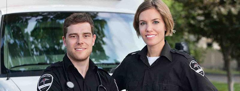 Two EMTs smiling